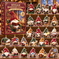 May include: A Hygge Bookworm Gnomes advent calendar box featuring a gnome reading in a chair, accompanied by 24 individual acrylic gnome ornaments. Each ornament depicts a gnome with a beard, hat, and various items like books, globes, or lanterns.