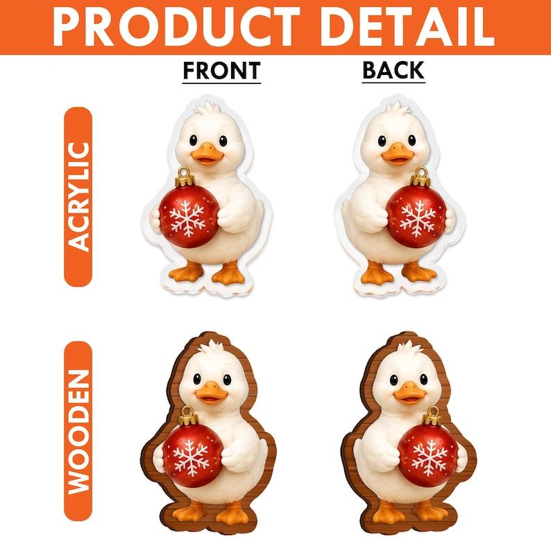 May include: A set of four duck ornaments featuring a white duck holding a red Christmas bauble with a white snowflake design. The top row shows acrylic versions, while the bottom row displays wooden versions, each with front and back views.