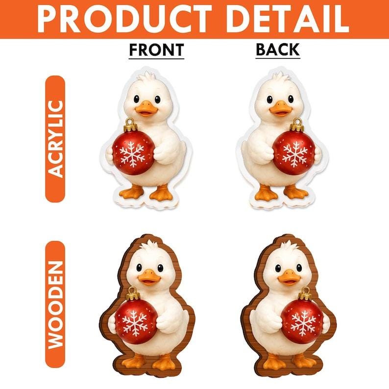 May include: A set of four duck ornaments featuring a white duck holding a red Christmas bauble with a white snowflake design. The top row shows acrylic versions, while the bottom row displays wooden versions, each with front and back views.